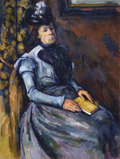 seated woman in blue paul cezanne